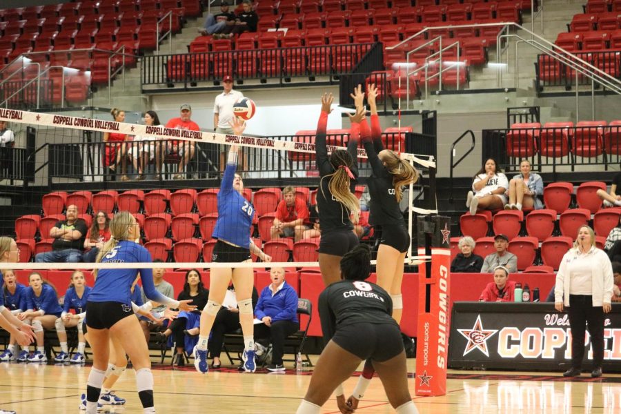 Coppell senior middle hitter Ekwe Anwah and junior opposite hitter Mira Klem block Hebron outside hitter Addison Vary at CHS Arena on Friday. Coppell defeated Hebron, 25-11, 25-22, 25-22.