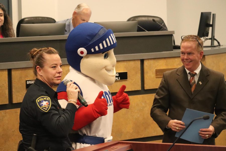 Coppell police officer Kelly Luther speaks about National Night Out at the Coppell City Council meeting on Tuesday, with an appearance from NNO mascot Nate the Knight. Coppell Mayor Wes Mays proclaimed Oct. 4, 2022 as National Night Out.