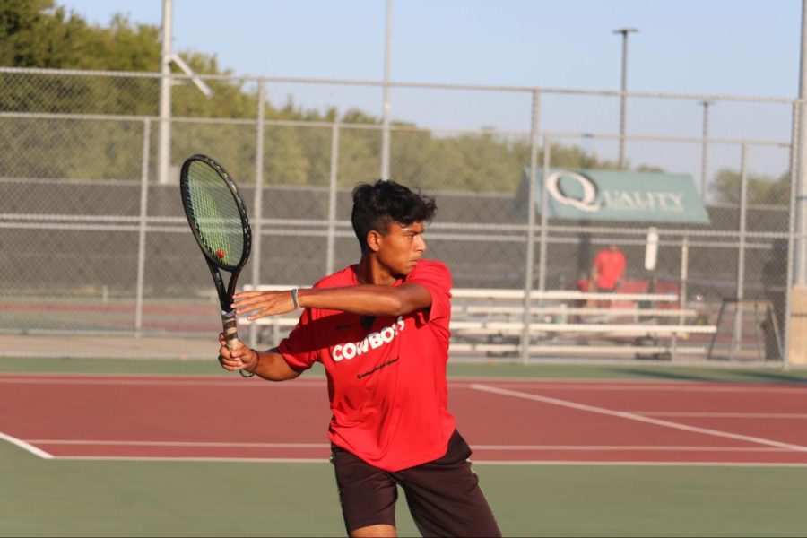 Coppell junior Isaac Joseph returns a ball during his singles match against Prosper at the Coppell Tennis Center on Friday. The Coppell tennis team defeated Prosper, 15-4. 