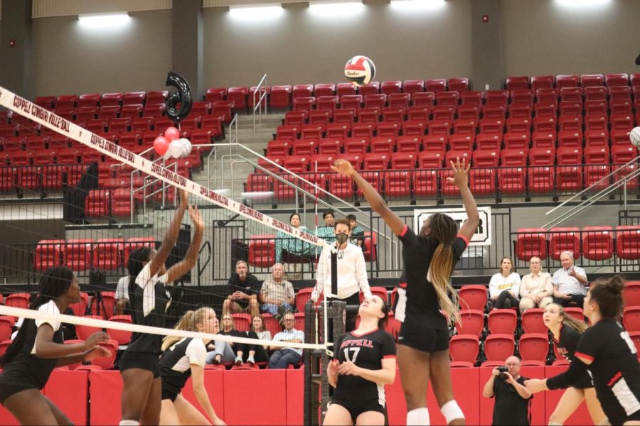 Coppell+senior+middle+blocker+Ekwe+Anwah+spikes+against+Plano+East+senior+opposite+hitter+Kinsey+Killion+at+the+CHS+Arena+on+Tuesday.+The+Cowgirls+defeated+Plano+East%2C+28-26%2C+26-24%2C+22-25%2C+25-21.
