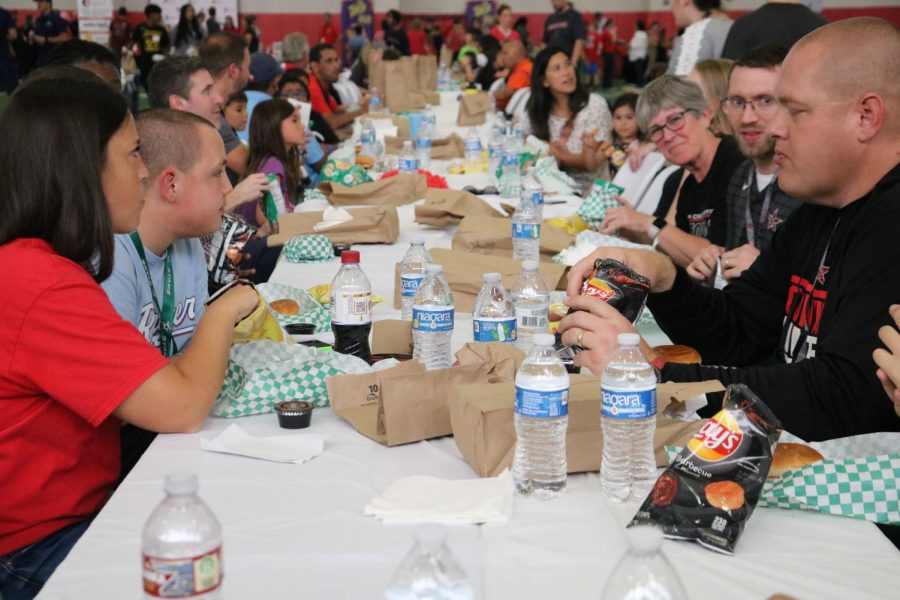 Coppell High School administrators and their families enjoy Dickeys barbecue on Friday in the CHS Field House at the annual Coppell ISD Annual Community Tailgate. The tailgate was prior to Coppells 43-35 victory over Hebron at Buddy Echols Field.