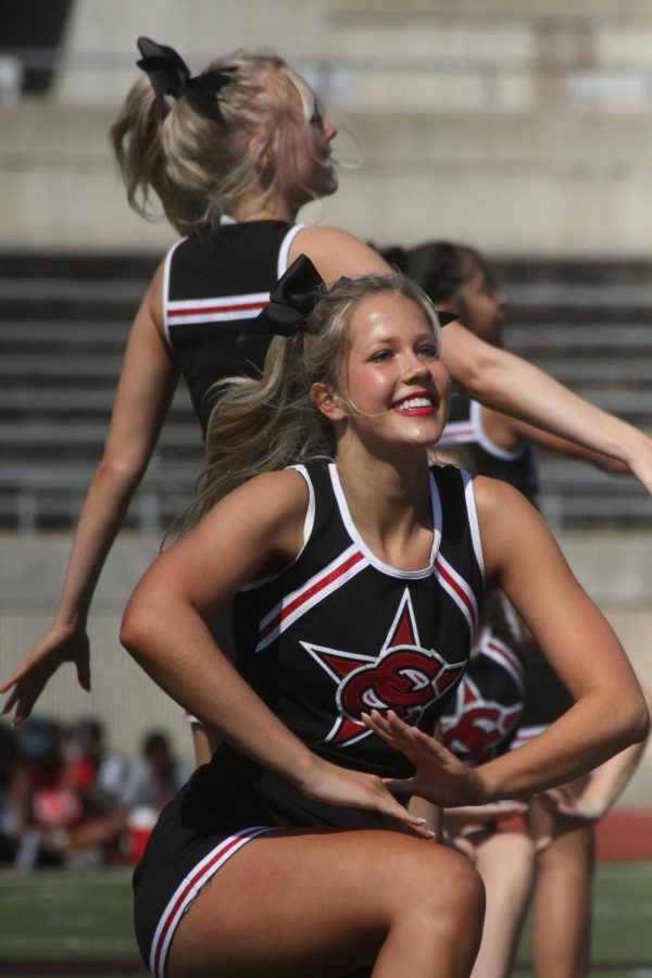 Coppell High School junior cheerleader Tali Colclasure performs a routine at Buddy Echols Field on Sept. 23.  Coppell High School held its annual Homecoming pep rally to celebrate various school groups and promote school spirit prior to the game against Plano West. 
