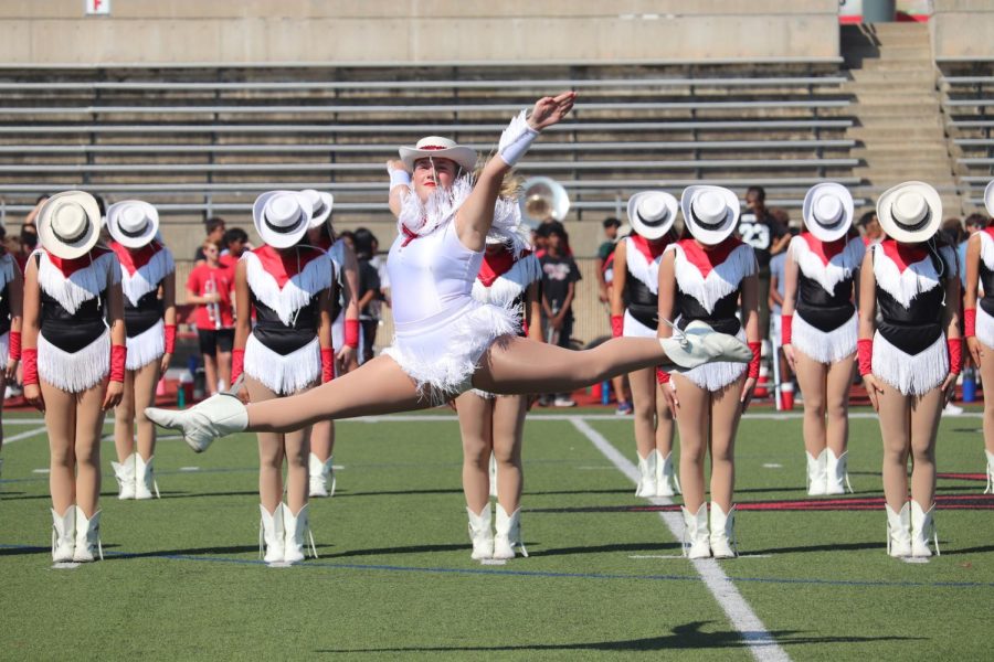 Coppell High School Lariettes senior lieutenant Lizzie Borchgardt performs the kickline routine “Wild West” at Buddy Echols Field on Sept. 23. Coppell High School held its annual Homecoming pep rally to celebrate various school groups and promote school spirit prior to the game against Plano West. 