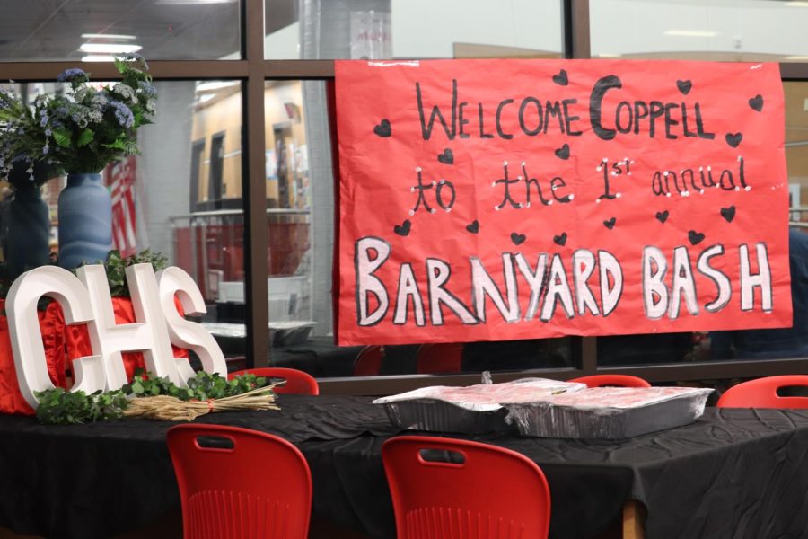Banners and other decorations are placed in the Coppell High School Library on Tuesday. Coppell High School student council invited other CISD student council members for dinner and leadership games as a part of the inaugural Barnyard Bash. 