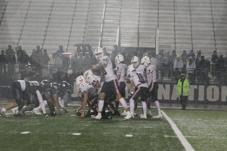 The Coppell offensive lines up on the line of scrimmage in the pouring rain. Beating the Jaguars 39-21 at Neil E. Wilson Stadium, Coppell has successfully clinched its spot in the playoffs moving 5-1 in the district.