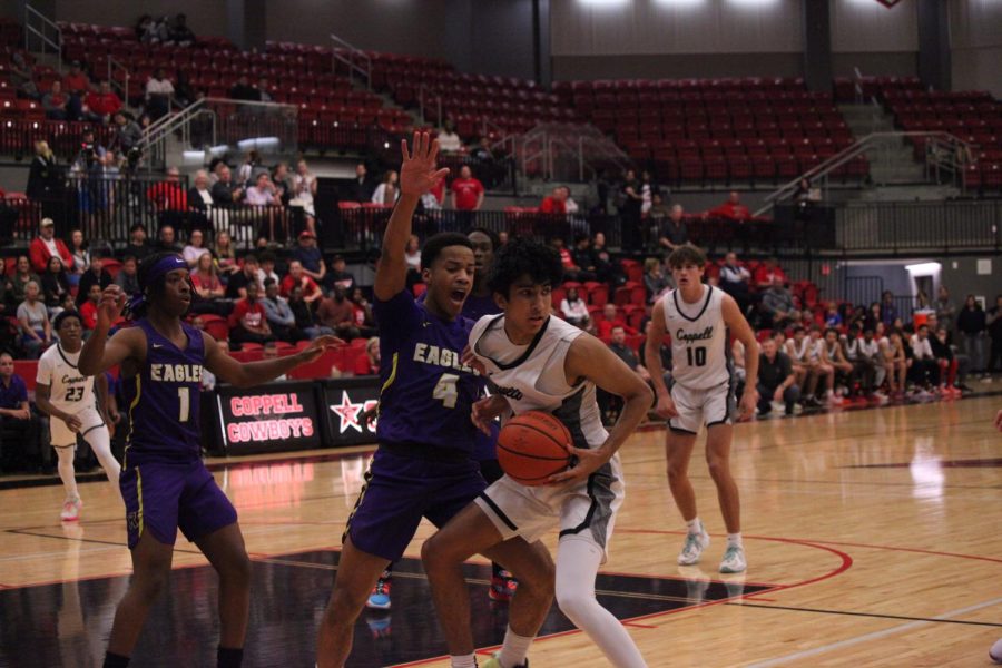 Coppell junior forward Arhan Lapsiwala looks to pass as hes guarded by Richardson senior shooting guard Pharaoh Amadi at CHS Arena on Tuesday. Coppell rallied to defeat Richardson, 68-64. Photo by Olivia Short.