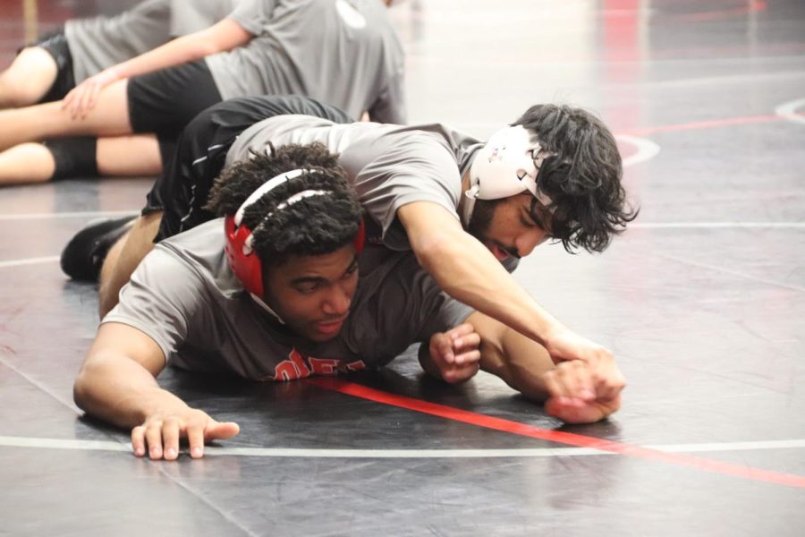 Coppell senior Jacob Abraham and senior Isaiah Francis practice on Thursday at the Coppell High School Field House. The Cowboys placed first at the Coppell Round-Up with a score of 5-0 on Nov. 18. 