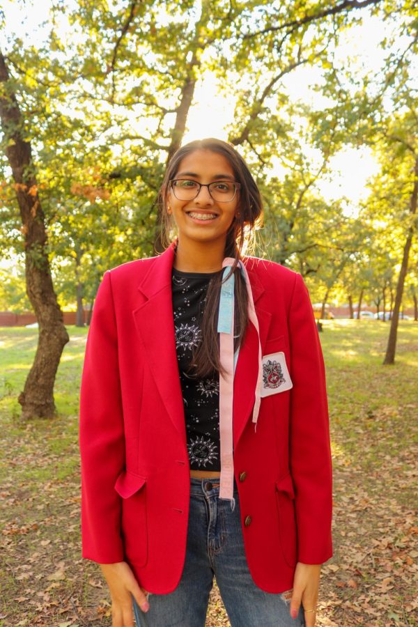 Coppell High School senior Rhythm Kandelwal wears a blue and pink ribbon in her hair representing her achievements in Coppell Band. Outside of Red Jackets, Khandelwal is involved in Coppell Band, Technology Science Association (TSA) and taekwondo. 