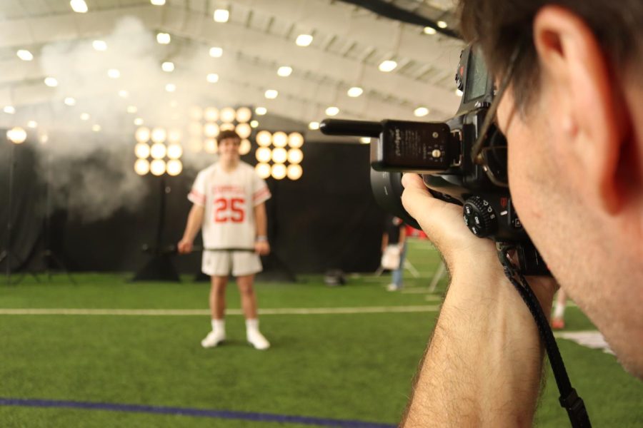 Concept 7 owner Frank Marott takes an individual portrait of Coppell High School senior Spencer Kutchins at the Coppell High School field house on Saturday. Marott has been a photographer for 25 years and serves the Coppell community. 