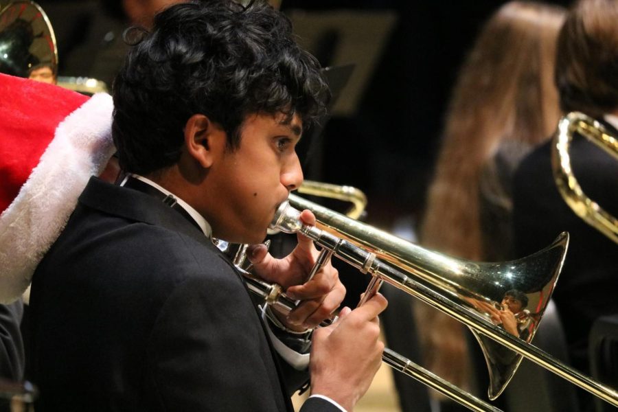Coppell High School junior trombonist Nikhil Kini plays “Adeste Fideles March” by H.J. Crosby along with Symphonic Band II in the CHS Auditorium on Tuesday. Coppell Band held its  annual winter concert on Monday and Tuesday.