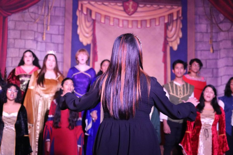 Coppell High School Choir student teacher Jamie Lam conducts “O Magnum Mysterium” by Evam Ramos during the Madrigals Feast in the CHS Commons on Friday. CHS Choir held its 28th annual Madrigal Feast on Friday and Saturday. 