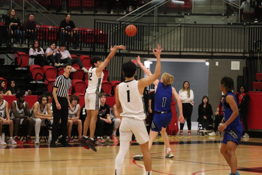 Coppell senior forward Alex Ninan shoots a 3-pointer against Hebron in CHS Arena on Jan. 6. Hebron defeated Coppell, 61-53. Aliza Abidi.
