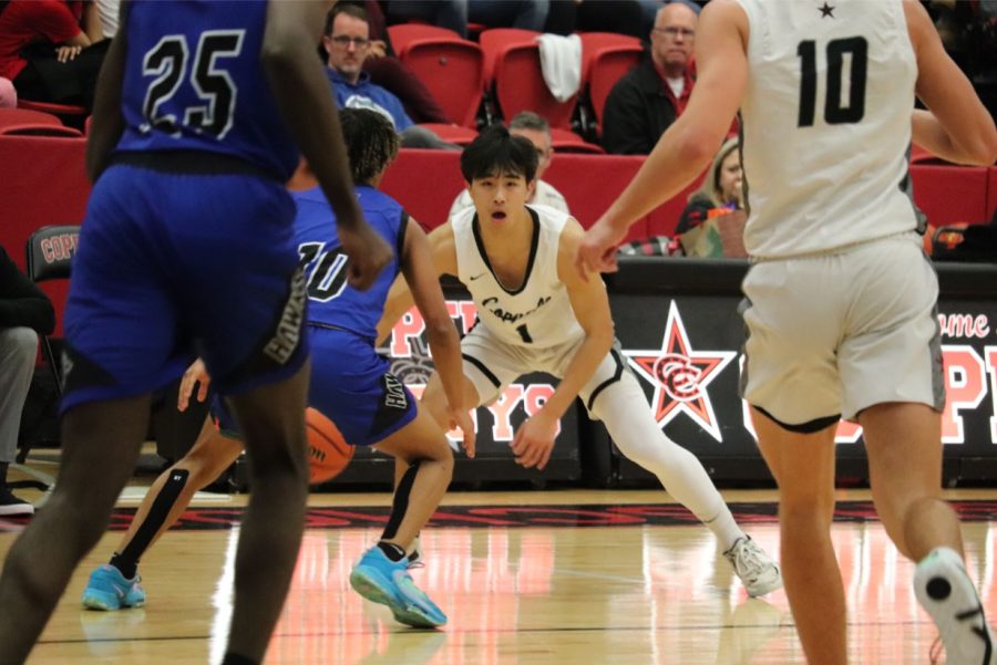 Coppell junior guard Alex Tung eyes the Hebron defense in CHS Arena on Friday. Hebron defeated the Cowboys, 61-53. Aliza Abidi.