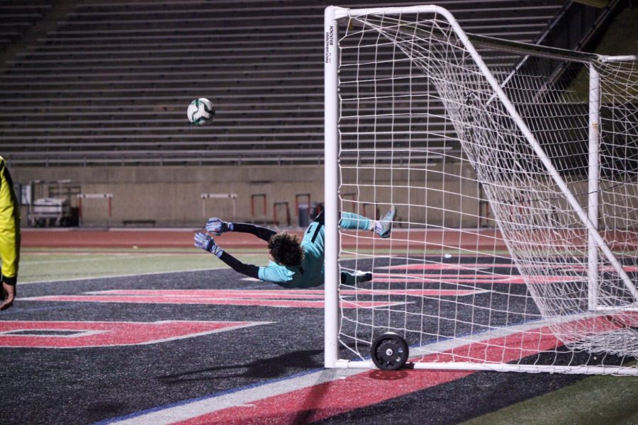 Coppell junior goalkeeper Jacob Campell saves a shot from San Antonio Harlan at Buddy Echols Field on Jan. 5. Coppell defeated Harlan in a shootout to break a tie of 0-0, winning by penalty kicks, 3-1. Photo by Olivia Short.