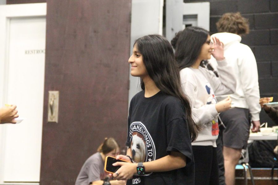 Coppell High School sophomore Drama Club member Komal Koranne greets other members of the club to begin the meeting on Wednesday in the CHS Black Box Theater. Koranne has the position of CHS9 liaison in which she aids the freshmen members to feel more comfortable in the new environment.
