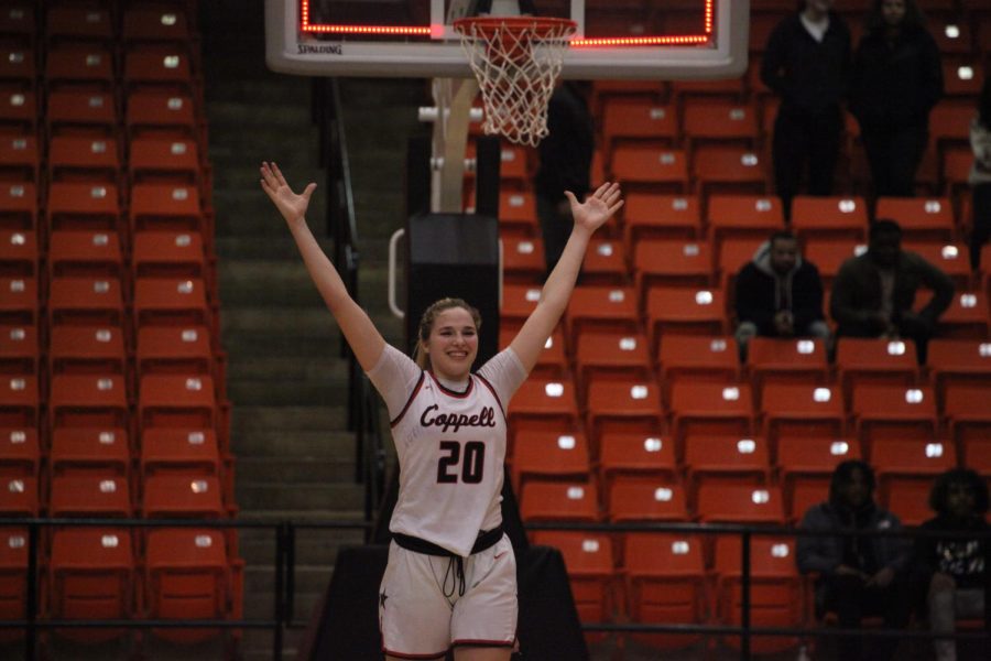 Coppell senior guard Jules LaMendola raises her arms as the final buzzer rings at Wilkerson-Greines Activity Center on Saturday. Coppell defeated Little Elm, 51-47, to advance to its first state tournament. Coppell plays Northside Clark in the Class 6A semifinals at 7 p.m. Friday at Alamodome in San Antonio.