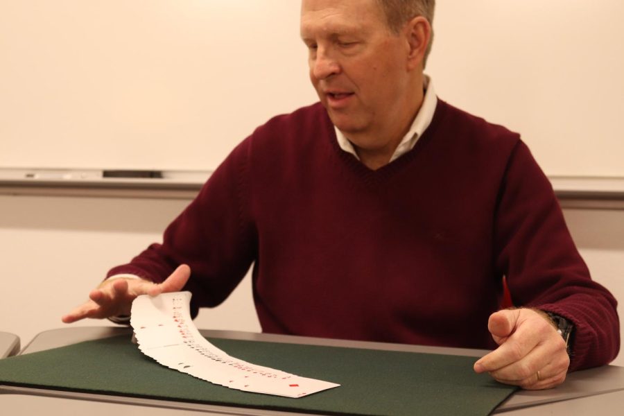 Coppell High School AP Statistics teacher Dr. Lowell Johnson 
does card tricks in his classroom on Feb. 8. Prior to teaching at CHS for the past nine years, Dr. Johnson worked in the Peace Corps and practiced law. 
