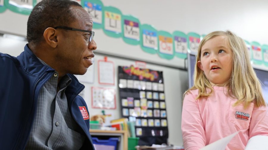 Coppell ISD trustee Anthony Hill talks to a Mockingbird Elementary School student during a board walk visit on Feb. 15. Hill has served on the board for 15 years and been involved in various projects for CISD, often attending multiple student events a week. 