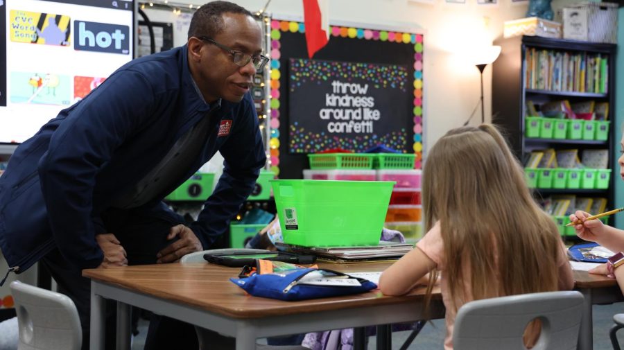 Coppell ISD trustee Anthony Hill talks to a Mockingbird Elementary School student during a board walk visit on Feb. 15. Hill has served on the board for 15 years and been involved in various projects for CISD, often attending multiple student events a week.