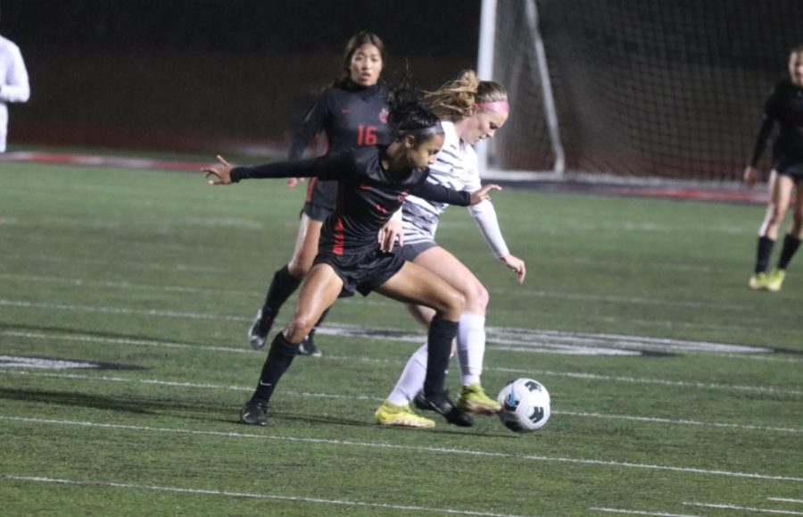 Coppell freshman forward Neerali Kapadia attempts to steal the ball from Hebron junior defender Ansley Beer at Buddy Echols Field on Tuesday. Kapadia has used her fighting spirit to fuel her passion for the sport. 