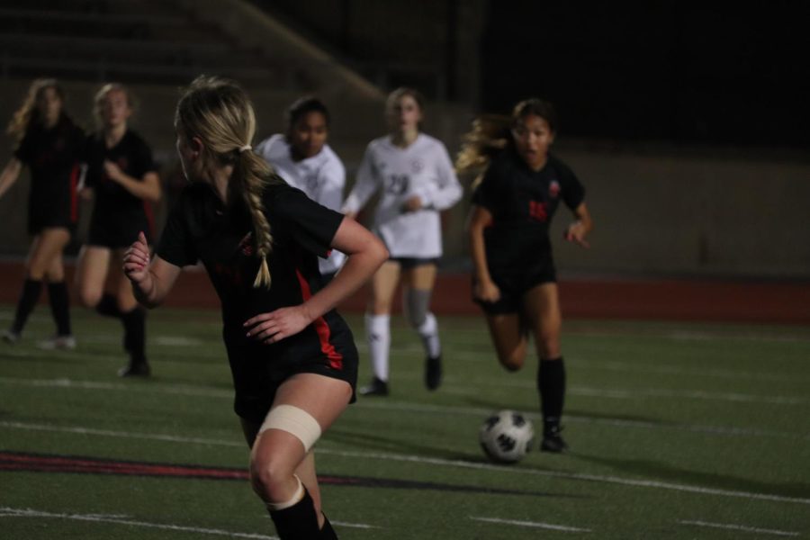 Coppell sophomore midfielder Summer Chen carries against Plano on Feb. 13 at Buddy Echols Field. With a 3-0 victory, the Coppell girls soccer team ended its losing streak.