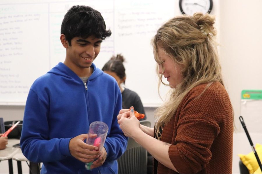 CHS9 health science teacher Amber Fragosa-Deck helps freshman Daniel Devasia with his respiratory system model where the balloon lid represents the diaphragm on Thursday. Fragosa-Deck has been a teacher at CHS9 for three years and was one of five nominees for teacher of the year this year. 

