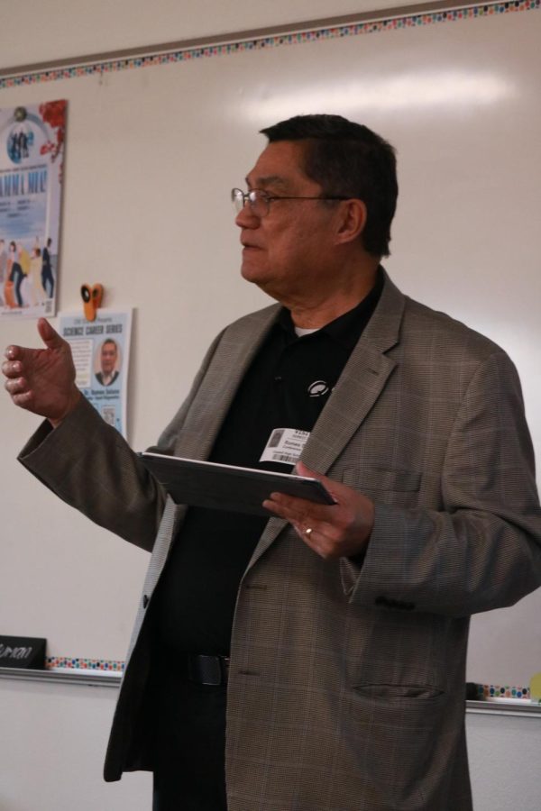 Coppell High School guest speaker and Quest Diagnostics director of research and development Dr. Romeo Solano delivers his presentation to students in E206. Dr. Solano came to CHS on Feb. 9  to speak on his journey from being an immigrant to Ph.D graduate to Quest Diagnostics.