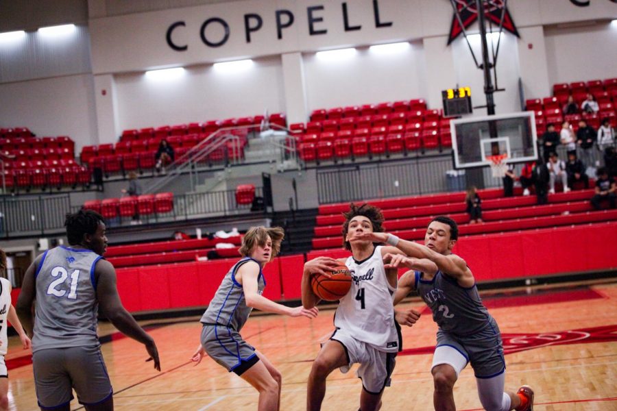 Coppell senior guard Trey Hill shoots a layup at CHS Arena against Plano West on Friday. Coppell defeated Plano West, 69-58. Photo by Angelina Liu 
