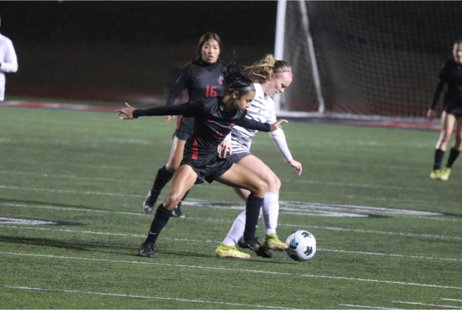 Coppell freshman forward Neerali Kapadia attempts to steal the ball from Hebron junior defender Ansley Beer at Buddy Echols Field on Tuesday. Hebron defeated Coppell, 3-1.