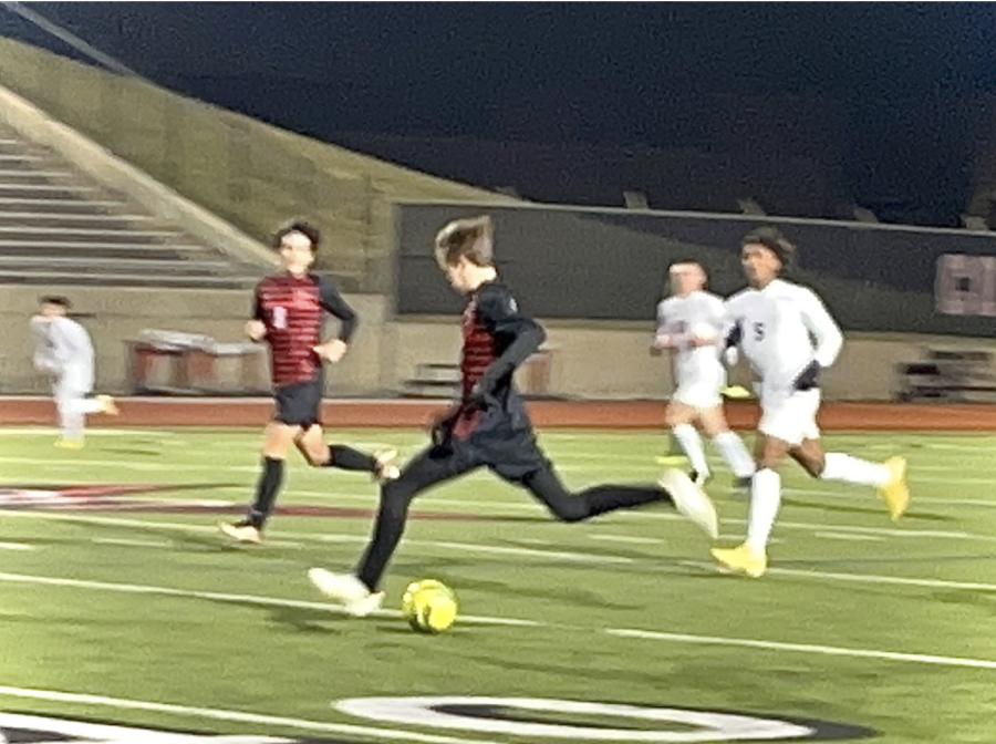 Coppell senior forward Alfred Fairchild makes a pass on Friday at Buddy Echols Field. The boys soccer team ends the game with a hard-fought 1-1 draw against Plano East. Photo by Wendy Le.