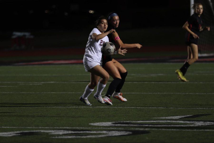 Coppell senior defender Kayleigh St. Peter shields Lewisville junior defender Hannah Augustyn at Buddy Echols Field on Tuesday. Coppell defeated Lewisville, 6-2.