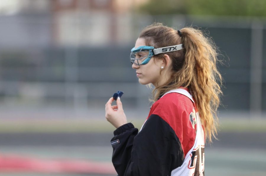 Coppell sophomore Sydney Frieder listens to drill instructions during practice on Monday at Coppell Middle School North. Frieder is an attackman for the Coppell girls varsity lacrosse team and has overcome obstacles throughout her lacrosse career.