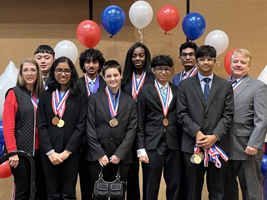The Coppell High School Academic Decathlon team lines up after its state competition on Feb. 26 in Frisco. The members are wearing their subject medals, medals received for exceptional work in a specific category in the Academic Decathlon competition, a gold medal being the highest honor. (Photo Courtesy Sai Kasiraman)
