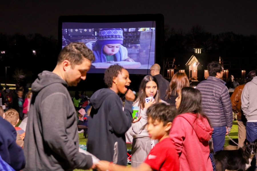 Attendees converse with one another during the Sunset Social at Andrew Brown Park East on March 10. The Sunset Social provided various activities and treats to accompany the movie. 