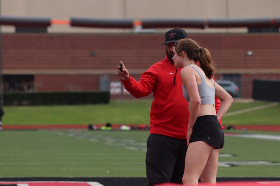 Coppell High School senior high jumper Megan Judd analyzes her jump with coach Zachary Gonzalez at Buddy Echols Field on March 21. Judd set a school record of five feet nine inches on the high jump at Coppell Relays on March 4.