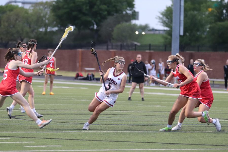 Coppell sophomore attack Wrenn Popp passes Parish Episcopal players at Coppell Middle School North on Wednesday. Coppell defeated Parish, 22-12.