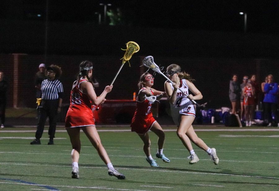 Coppell sophomore midfielder Kate Nelson passes Parish Episcopal players at Coppell Middle School North on Wednesday. Coppell defeated Parish, 22-12.  