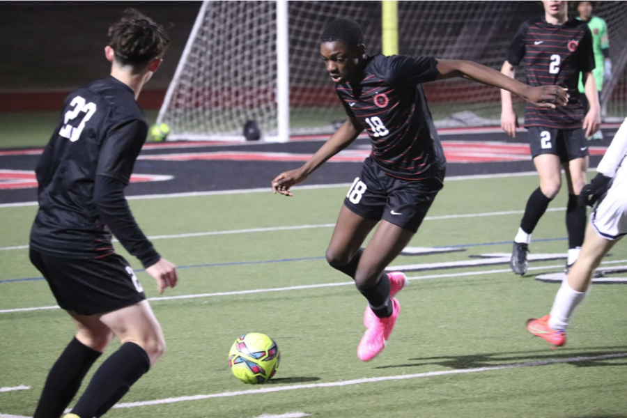 Coppell freshman JV defender Mohamed Ouedraogo dribbles against  Flower Mound at Buddy Echols Field on Feb 10. Ouedraogo has been invested in soccer for as long as he can remember and hopes to play professionally. Photo by Trey Boudreaux.