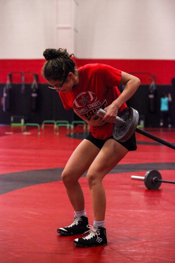 Coppell junior wrestler Ava Payne does landmines during wrestling practice on March 4. Weight lifting bolsters athletes in countless ways by improving assets like strength as well as motivation and discipline.