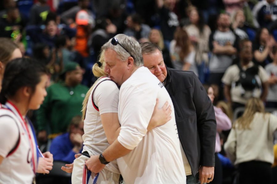 Coppell ISD Athletics Director Kit Pehl and Superintendent Dr. Brad Hunt congratulate and console the Cowgirls at Alamodome at San Antonio on Friday. Coppell narrowly fell to Northside Clark, 49-48, in the Class 6A semifinals on a last second 3-pointer by Clark’s Natalie Huff.