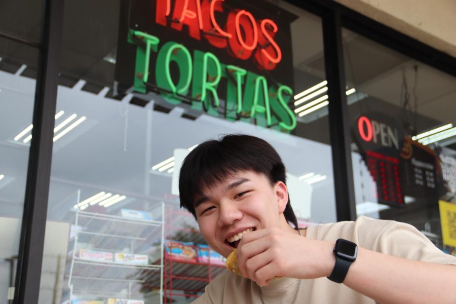 Coppell High School senior William Li eats a Mexican Street Taco from Speedy K Gas Station on the intersection of Sandy Lake Road and Moore Road on Friday. Li enjoys trying cultural cuisines as a vessel to experience new cultures.