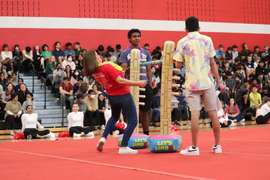 CHS9 Spanish teacher Reyna Conger limbos during the spring pep rally on April 21 in the campus gym. The biannual pep rally followed a Hawaiian theme and was hosted by the Student Council Executive Board.