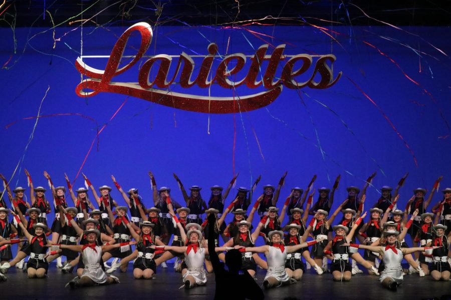 Coppell Lariettes perform their finale as a fan enthusiastically jumps up from their seat. The Lariettes Spring Show was performed on Friday at 7pm to showcase the dancers’ skills from the year. 