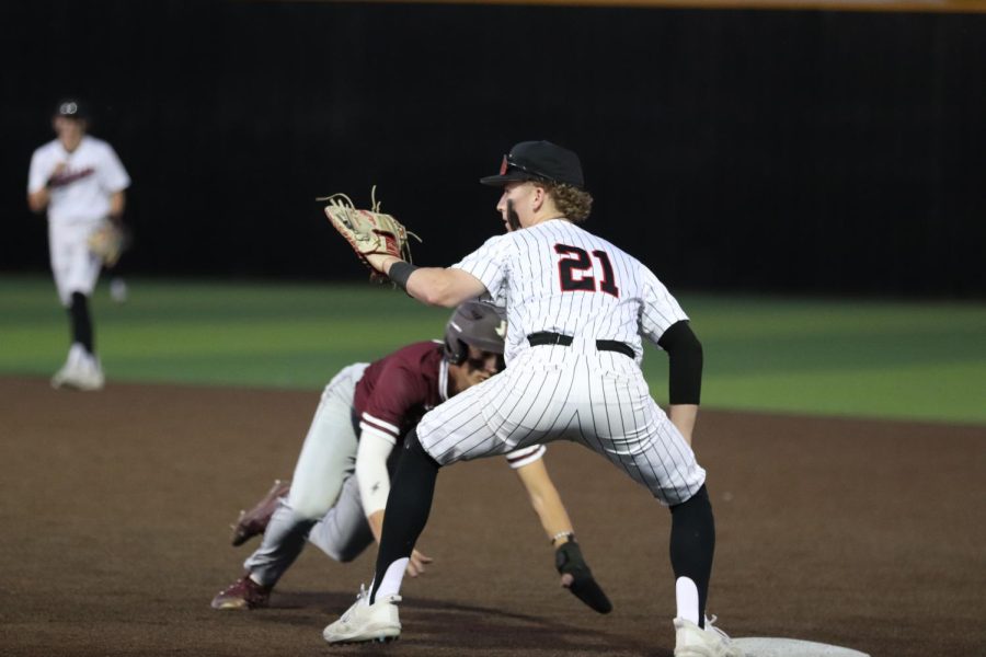 Coppell senior first baseman Andrew Schultz catches a ball thrown to first from senior pitcher Bryan Raitz to tag Lewisville out at the Coppell ISD Baseball/Softball Complex on Friday night. Coppell defeated Lewisville, 1-0.