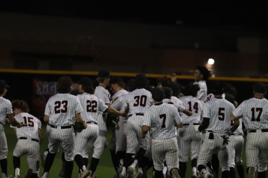 The+Coppell+baseball+team+celebrates+its+win+against+Lewisville+at+the+Coppell+ISD+Baseball%2FSoftball+Complex+on+Friday+night.+The+Cowboys+defeated+the+Farmers%2C+1-0.+