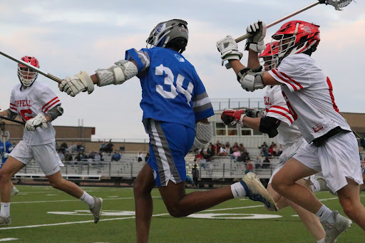 Coppell senior midfield Carson Boutte and Coppell freshman Duncan Ross chase Frisco senior midfield Harrison Montgomery for possession while Coppell freshman Jack Behr blocks. The Coppell boys lacrosse team defeated Frisco, 9-2, at Lesley field on Tuesday.
