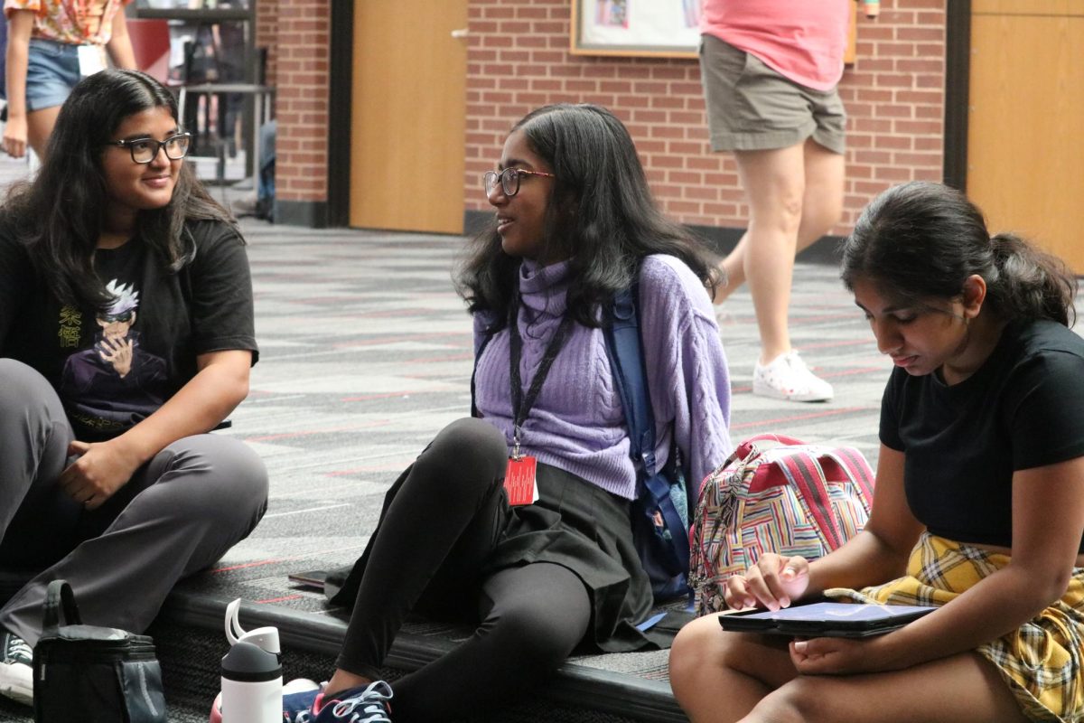 Coppell High School juniors Srishti Behera, Sai Kasiraman and Niyathi Yamunan talk in the hallway before the school day starts on Wednesday. Tuesday marked the first day of the 2023-24 school year for Coppell ISD. 