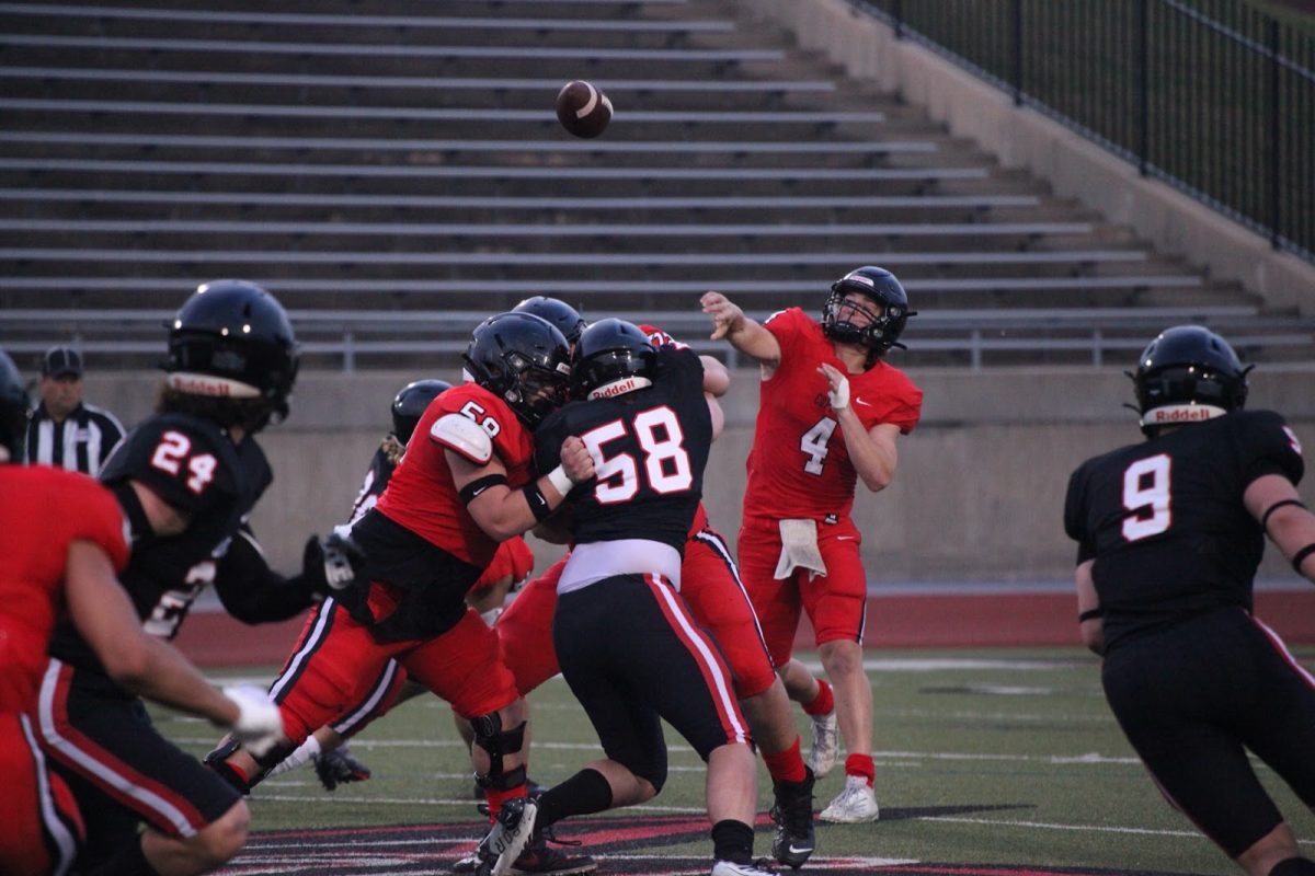 Coppell junior quarterback Edward Griffin locates one of his receivers during the Coppell Red and Black scrimmage. After preparing for weeks, the Coppell football team faces Sachse tonight at Buddy Echols Field at 8 p.m. for the season opener. 