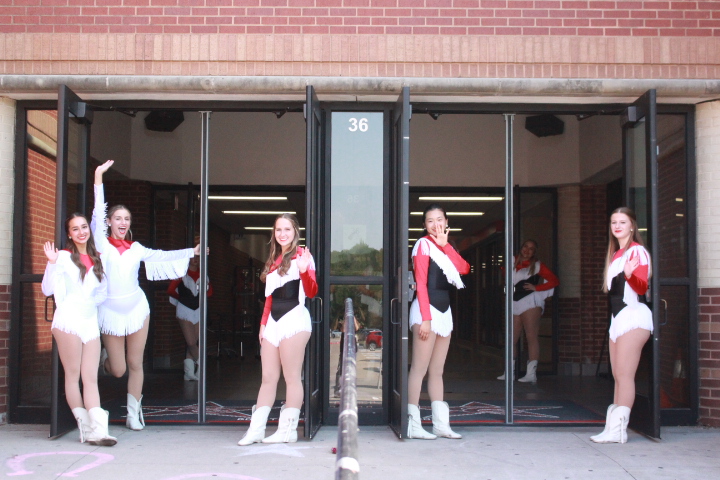 Coppell High School Lariettes welcome visitors to the Lariette Spaghetti Dinner in the Large Commons on Friday. The Lariette Spaghetti Dinner is an annual fundraiser and community event celebrating the beginning of the football season.
