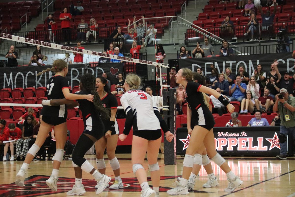 The Coppell volleyball team celebrates after winning a point against Flower Mound Marcus at CHS Arena on Friday.  After the Coppell volleyball team graduated 10 seniors last year, the team is overcoming the struggles of having a younger team.